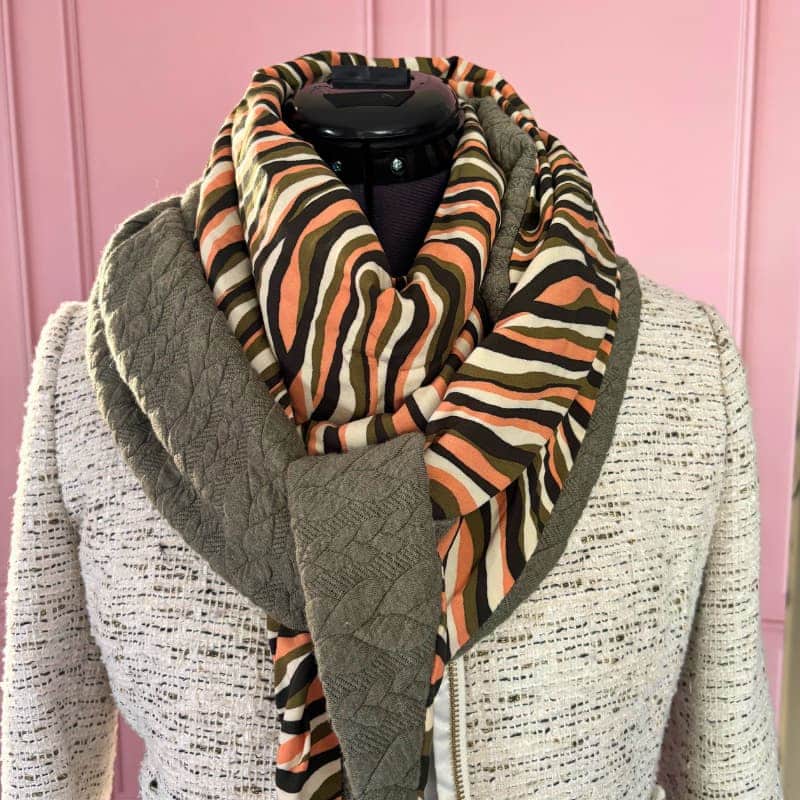 Foulard triangle réversible femme kaki saumon, tissu rayé orange et vert, doublure sweat kaki matelassée, présenté sur mannequin.