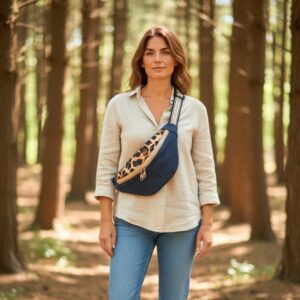 Femme portant une sacoche banane Maison Pivoine en jean’s recyclé et viscose léopard, en forêt, style décontracté chic.